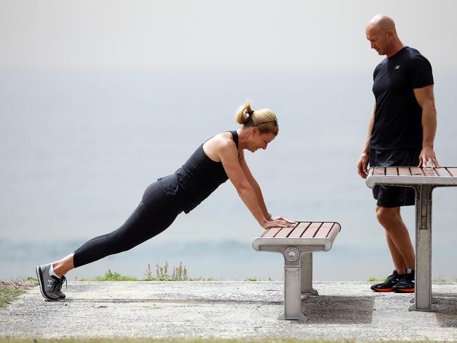 Hutton shows Adam MacDougall how she works out. Picture: Sam Ruttyn