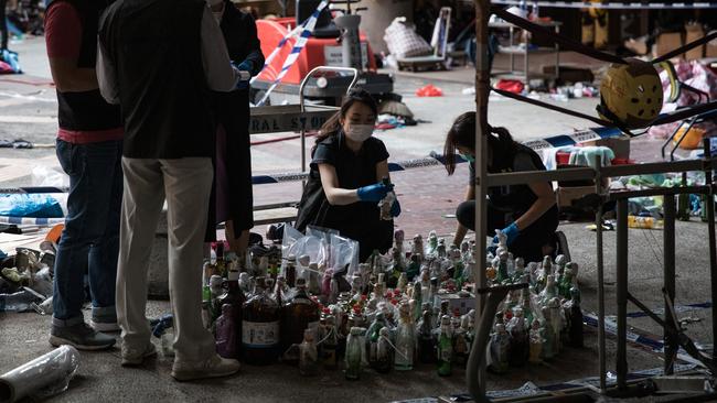 Police inspecting and cataloguing thousands of molotov cocktails found at the Hong Kong Polytechnic University campus. Picture: Getty