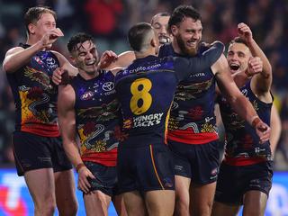 ADELAIDE, AUSTRALIA - JULY 13: Riley Thilthorpe of the Crows celebrates a goal with team mates during the 2024 AFL Round 18 match between the Adelaide Crows and the St Kilda Saints at Adelaide Oval on July 13, 2024 in Adelaide, Australia. (Photo by Sarah Reed/AFL Photos via Getty Images)
