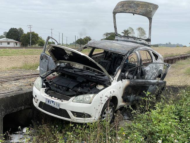 Bystanders said after becoming stuck, two men climbed out of the car and set it on fire. Photo: Fergus Gregg