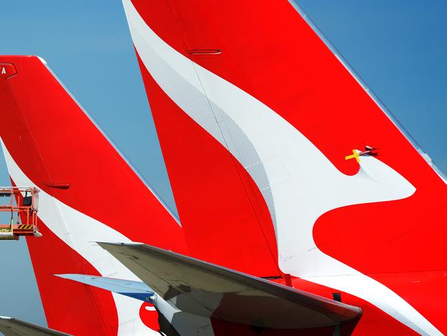 MELBOURNE, AUSTRALIA - NewsWire Photos NOVEMBER 22, 2021: A maintenance worker inspects the tails of QANTAS planes parked at Melbourne Airport. Picture: NCA NewsWire / Andrew Henshaw