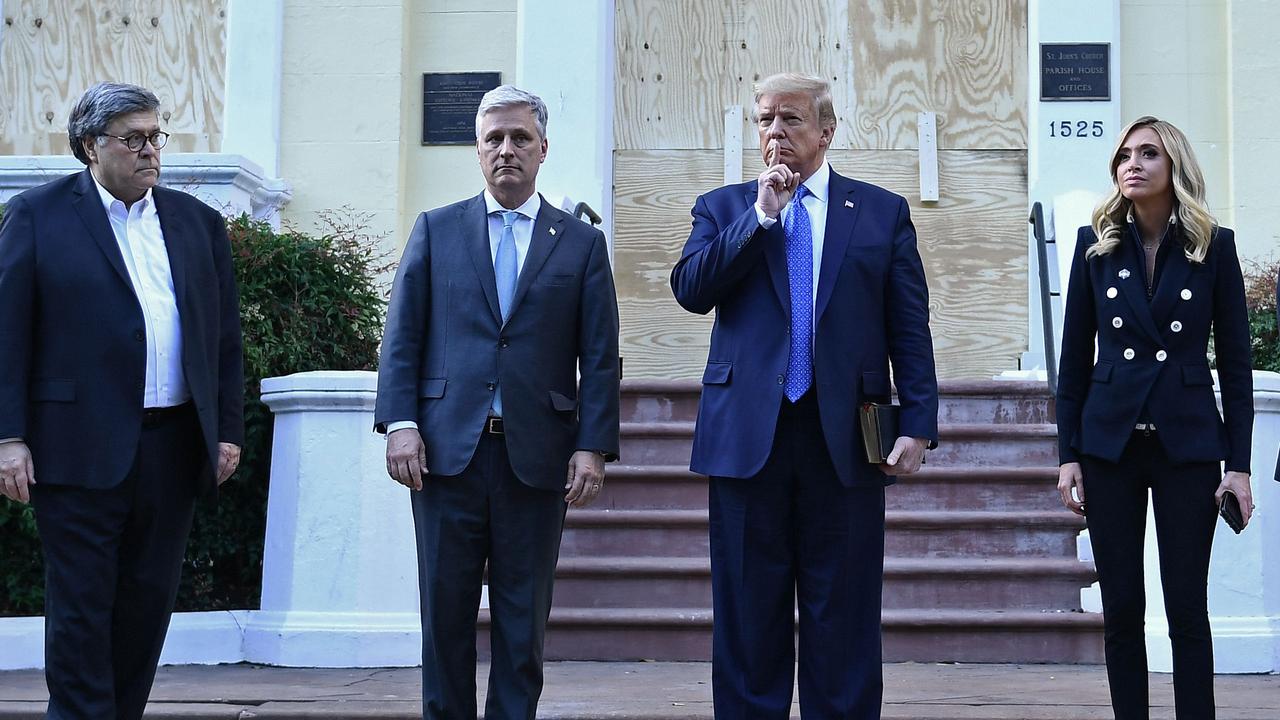 Donald Trump with US Attorney-General William Barr, White House Chief of Staff Mark Meadows and White House press secretary Kayleigh McEnany. Picture: Brendan Smialowski/AFP