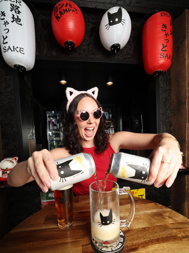 Olivia Lee at Miami brewery, Roji Cat, pouring a glass of their award-winning Chilli Cat beer. Pic Annette Dew