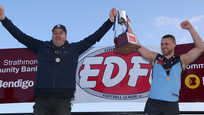 Aberfeldie coach Adam Potter and captain Luke Davis celebrate with the 2017 premiership trophy. Picture: Hamish Blair