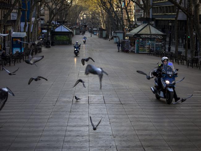 Catalonian police officers patrol along La Ramblas in Barcelona, Spain, Sunday, March 15, 2020. Picture: AP