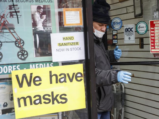 A customer leaves a shop advertising personal protective equipment in New York. Picture: AP