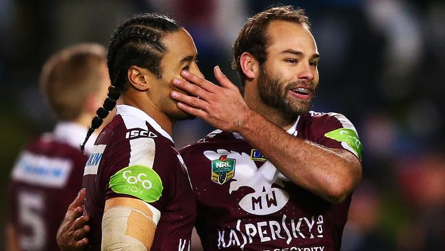 Manly's Brett Stewart celebrates a try with Steve Matai.