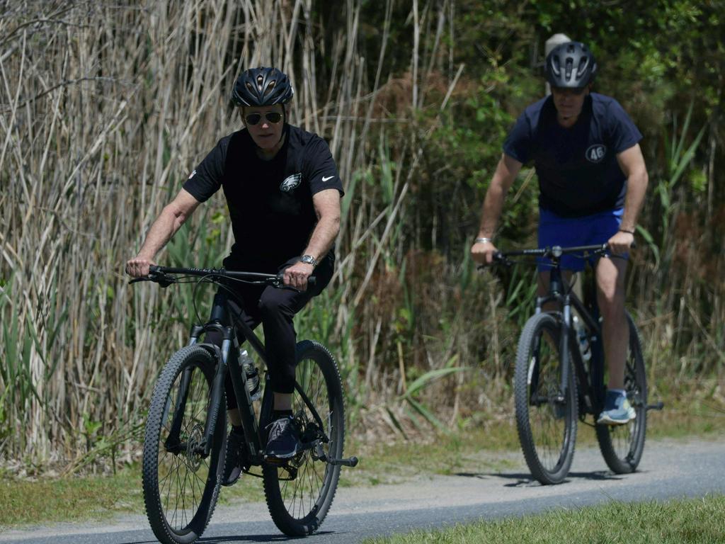 US President Joe Biden cycling with his son Hunter. Picture: Samuel Corum (AFP)