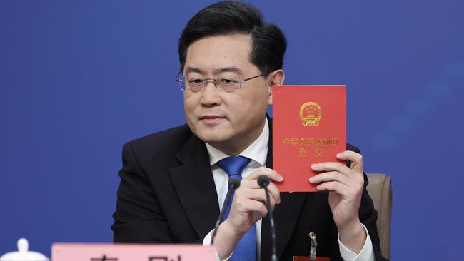 Foreign Minister Qin Gang holds a copy of China's constitution during a press conference in Beijing. Picture: Getty Images.