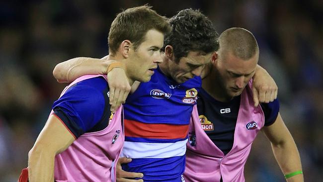 Bob Murphy is helped from the field after rupturing his ACL earlier this season. Picture: Wayne Ludbey
