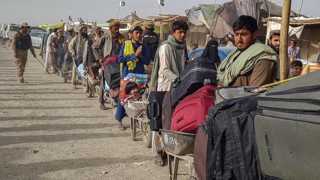 Afghans queue at the Pakistan-Afghanistan border crossing point in Chaman on Tuesday. Picture: AFP