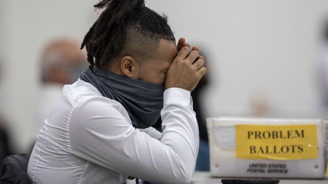 A vote counter takes a break after sorting through ballots in Detroit. Picture: Getty