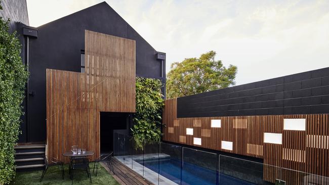 The striking wall of timber battens features LED light boxes.