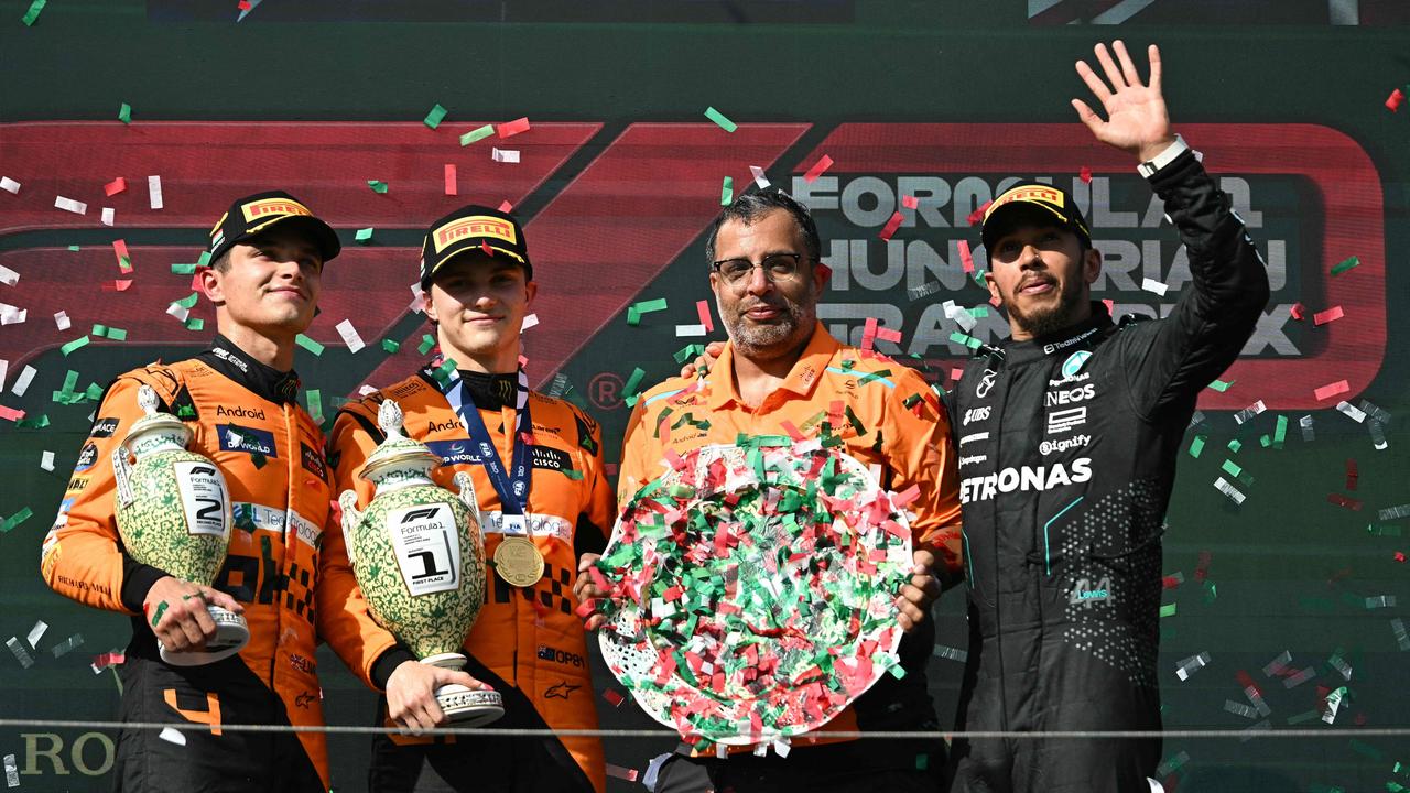 Second placed Team McLaren’z Lando Norris, winner Oscar Piastri, racing director Randy Singh and third placed Mercedes driver Lewis Hamilton celebrate on the podium after the Formula One Hungarian Grand Prix. Picture: Attila Kisbenedek/AFP