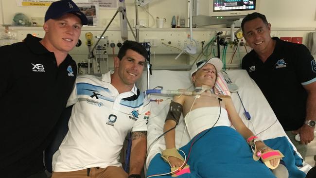 Louie Mould, 12, at Westmead hospital with Cronulla Sharks player Jack Williams, Michael Ennis and Shane Flanagan.