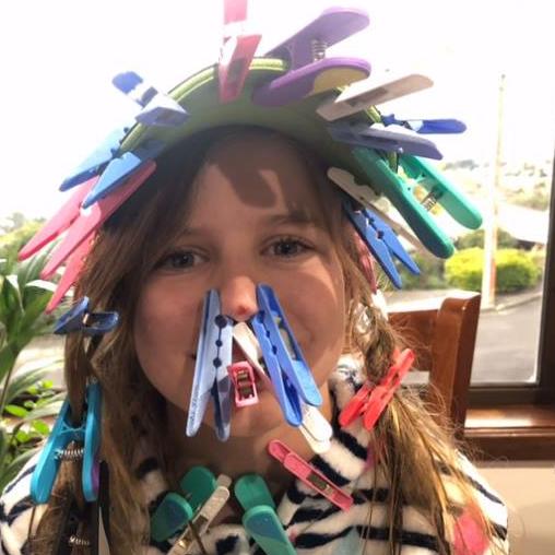 Ruby Harris, 10, seeing how many pegs she can fit on her face.