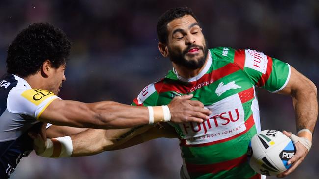 Greg Inglis pushes aside Matthew Wright on his way to a try against the Cowboys.