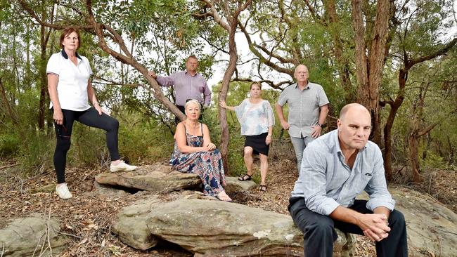 Kellyville Residents Action Group members Tim Opren (front R), with (back L-R) Gail Butler, Brett O'Connor, Nola Bostridge, Di Opren, &amp; Kevin Bostridge, near a critically endangered Eucalyptus Cattai at Kellyville. Residents are objecting to a Lyon Group development proposal for 71 homes to be built in the Cattai Creek Reserve. (AAP IMAGE / Troy Snook)