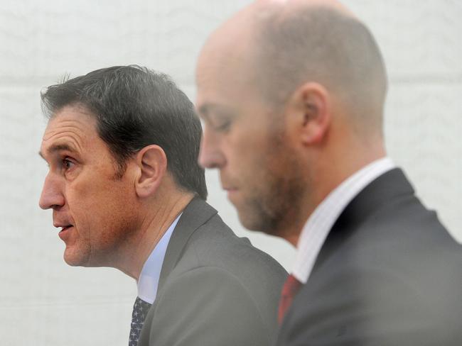 Cricket Australia CEO James Sutherland (L) and Australian Cricketers' Association CEO Alistair Nicholson attend a press conference in Melbourne on August 3, 2017. Australia's bruising and protracted cricket pay dispute was finally resolved on August 3 with players and management agreeing on a new "in-principle" deal, ensuring upcoming series against Bangladesh, India and England can go ahead. / AFP PHOTO / Mal Fairclough