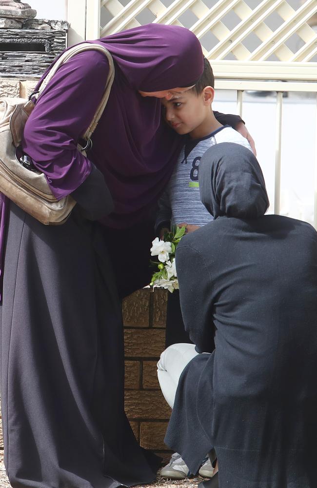 Parents comfort a fellow student at the school. Picture: Hollie Adams/The Australian