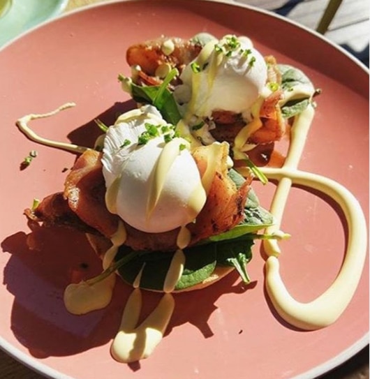 Mt Gravatt's The LoveWell Project serves eggs benedict on an English Muffin topped with spinach, hollandaise and the choice of ham, smoked salmon or bacon or vegetarian options. Picture: Instagram/thelovewellproject