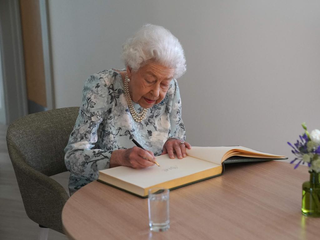 The Queen signs a guest book to officially open the new building of Thames Hospice. Picture: AFP