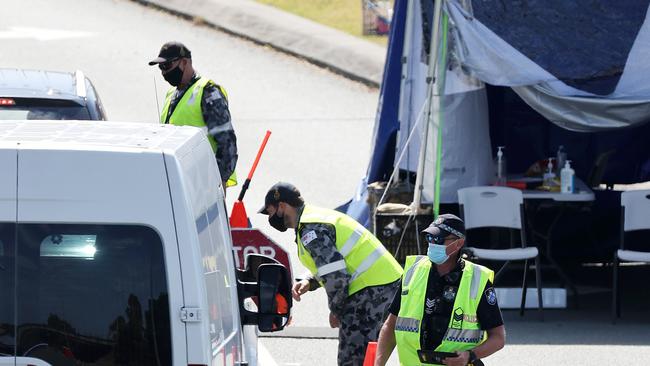 Police and the army officers at the Queensland border at Coolangatta. Picture: NIGEL HALLETT.