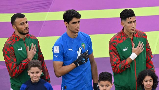 Morocco's goalkeeper Yassine Bounou (C) sings the team song before the match against Belgium.