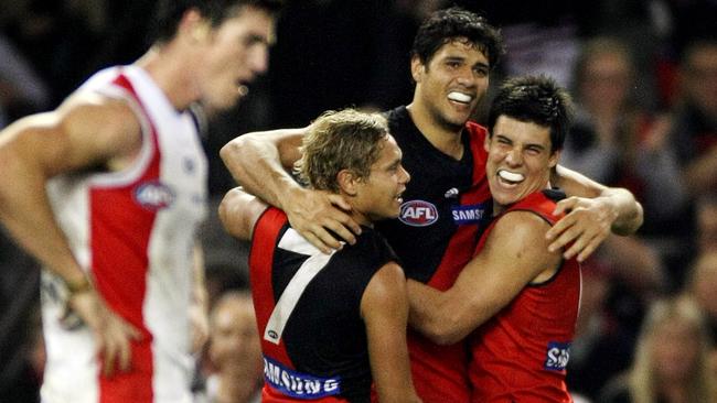 Paddy Ryder celebrates with Leroy Jetta and Angus Monfries while playing for Essendon in 2010.