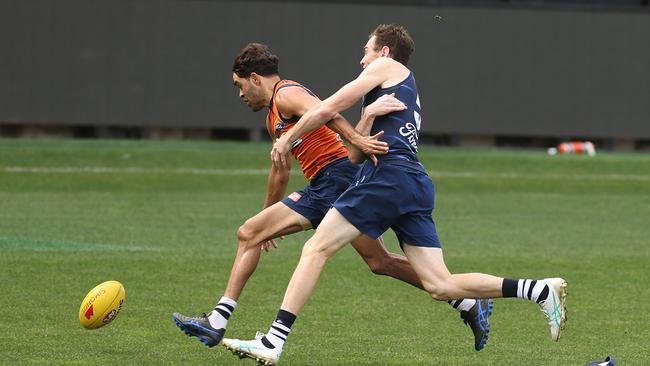 Jack Martin attacks the ball under pressure from Jeremy Cameron at Cats training. Picture: Alison Wynd