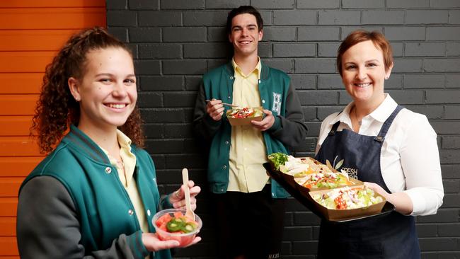 Henry Kendall High School students Siobhan Wilby and Oliver Worrad with canteen franchisee Jackie Stansfield and some healthy choices on offer at the school canteen. Picture: Sue Graham