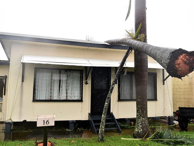 A house in Airlie is left with a gapping hole and a tree on the roof during Cyclone Debbie. Picture: Alix Sweeney