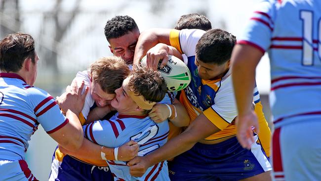 St Greg's Charlie Lennon is wrapped up in some strong defence from Blacktown Pats. Picture: Toby Zerna