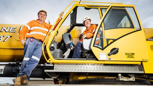 Crane Operators Salih Zanatta and Ramo Imsirovic at their Dysart headquarters, who have an eight year relationship with Adani and will hit the ground running after the Adani mine final approval. Picture: Lachie Millard