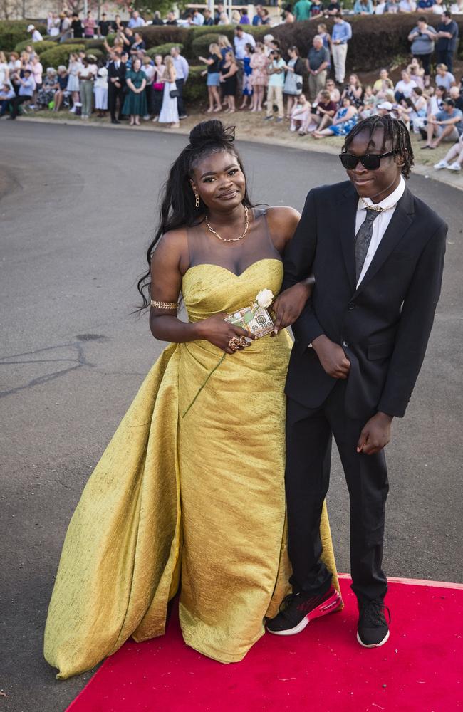 Graduate Clairy Mukeba with Enock Mukeba at Harristown State High School formal at Highfields Cultural Centre, Friday, November 17, 2023. Picture: Kevin Farmer