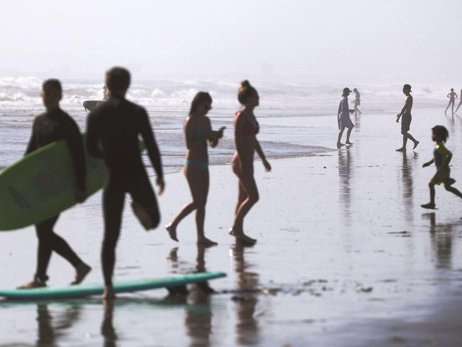 People gather on Huntington Beach which remains open amid the coronavirus pandemic. Picture: Getty Images