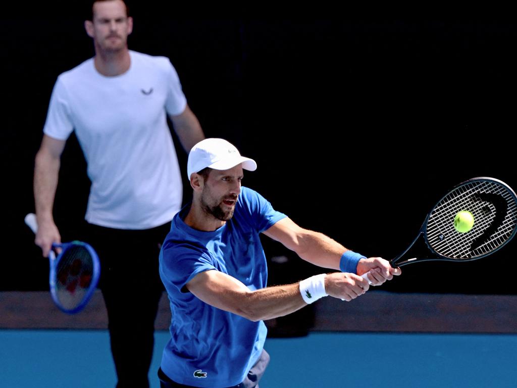 Serbia's Novak Djokovic (R) hits a return as coach Andy Murray looks on. Picture: AFP