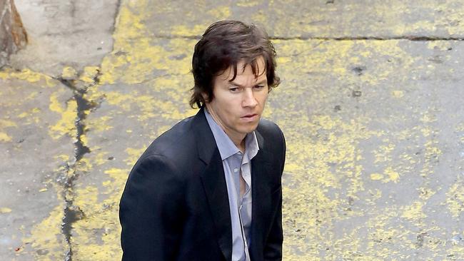 UK CLIENTS MUST CREDIT: AKM-GSI ONLY Mark Wahlberg gets to work this afternoon in Los Angeles, where he filmed scenes for his upcoming movie, "The Gambler". The actor looked slim wearing a suit and at one point had to get his belt adjusted by a crew member. Mark filmed a scene with his costar Michael K. Williams in an alleyway, where it looks like Mark's character gets into some trouble. However, in between takes, Mark and Michael had some laughs. Pictured: Mark Wahlberg Ref: SPL693042 030214 Picture by: AKM-GSI / Splash News Splash News and Pictures Los Angeles: 310-821-2666 New York: 212-619-2666 London: 870-934-2666 photodesk@splashnews.com