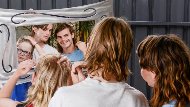 Edwardstown brothers Harry and Max Downs and friend Ethan McAneney check out their mullets. Picture: Brenton Edwards