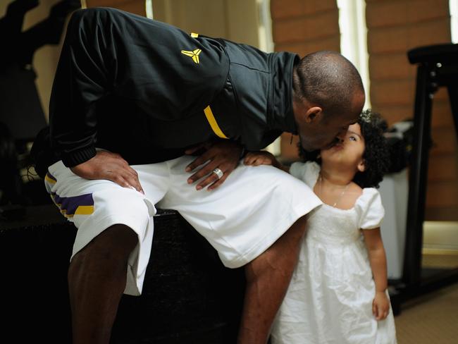 Kobe Bryant of the Los Angeles Lakers kisses his daughter Gianna Bryant during a photo session on March 29, 2008 at his home in Newport Beach, California. Picture: Getty