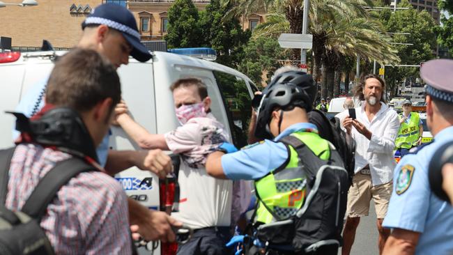 A man is arrested outside the funeral of Cardinal George Pell at St Mary's Cathedral. Picture: Nicholas Eagar