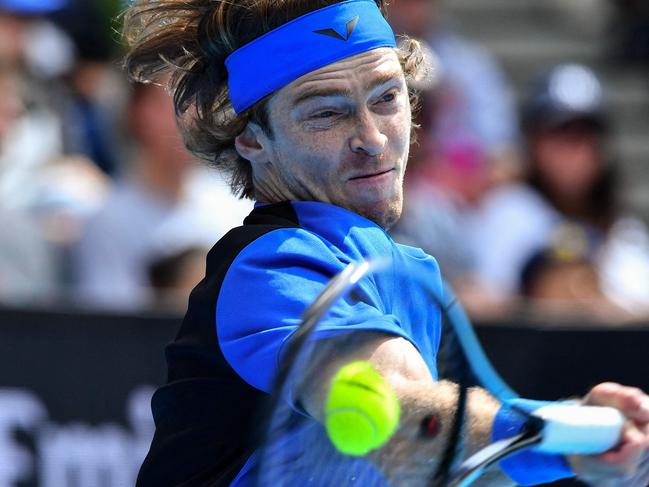 Russia's Andrey Rublev hits a return against Finland's Emil Ruusuvuori during their men's singles match on day four of the Australian Open tennis tournament in Melbourne on January 19, 2023. (Photo by Paul CROCK / AFP) / -- IMAGE RESTRICTED TO EDITORIAL USE - STRICTLY NO COMMERCIAL USE --