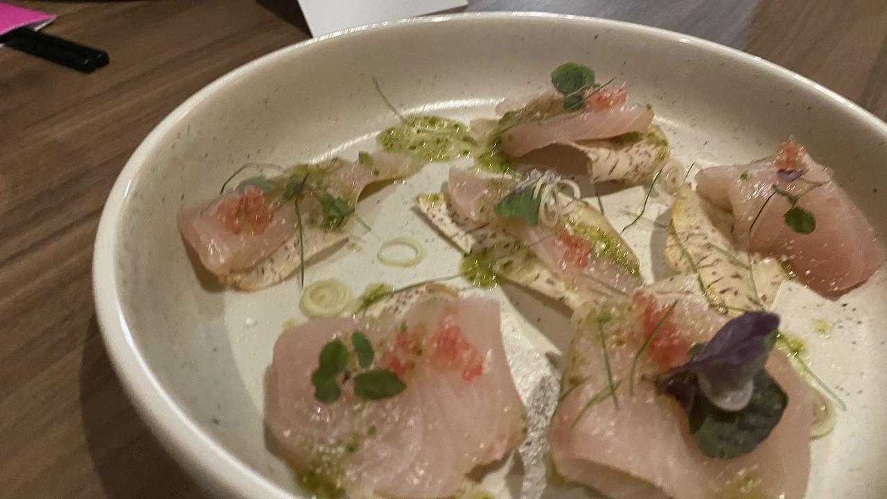 Raw kingfish with green nahm jim, taro chips, finger lime and shiso. Picture: Grace McKinnon