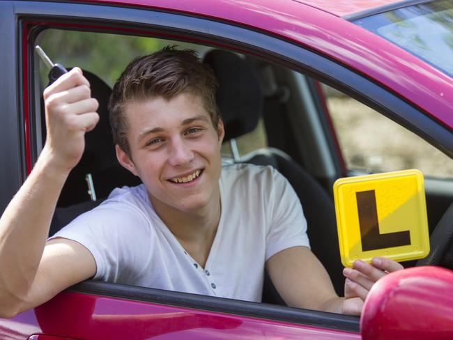 Learner driver with car keys and an Australian L-plate. istock