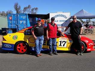 FAST CARS: Keith Edwards, of Withcott, with legend Dick Johnson and son Steve Johnson, in front of Keith's replica car. Picture: Contributed