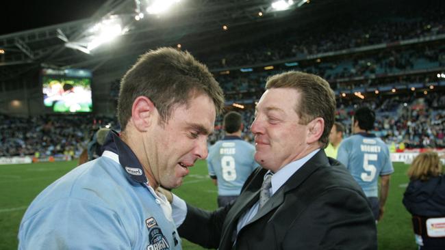 JUL 07, 2004: Blues' Brad Fittler (L) celebrates their win with coach Phil Gould after Game three of State of Origin series NSW vs. Qld at Telstra Stadium. PicGregg/Porteous. Rugby League sport profile