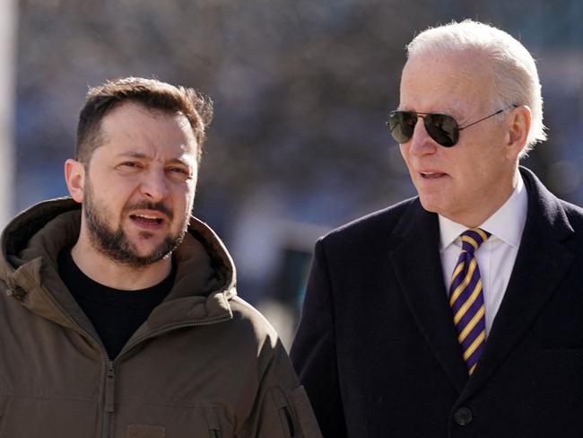 (FILES) US President Joe Biden (R) walks next to Ukrainian President Volodymyr Zelensky (L) as he arrives for a visit in Kyiv on February 20, 2023. NATO will lay out a path of reforms for Ukraine so that it can eventually join the alliance, but without giving a "timetable," White House National Security Advisor Jake Sullivan said jULY 11, 2023. (Photo by Dimitar DILKOFF / AFP)