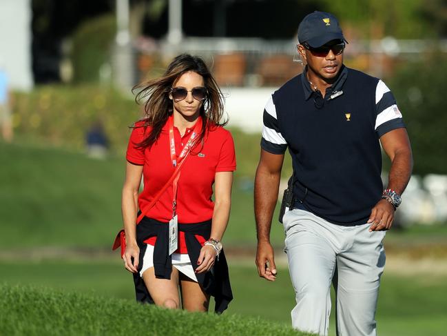 (L-R) Erica Herman pictured with Tiger Woods at the 2017 Presidents Cup. Picture: AFP