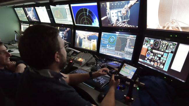 Crewmen on the French ship Atalante guide the robot to the sea floor. Picture: AAP.