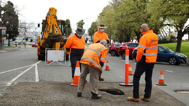 COGG workers investigate a sinkhole near the Ritz on Bellarine St. Picture: Alison Wynd